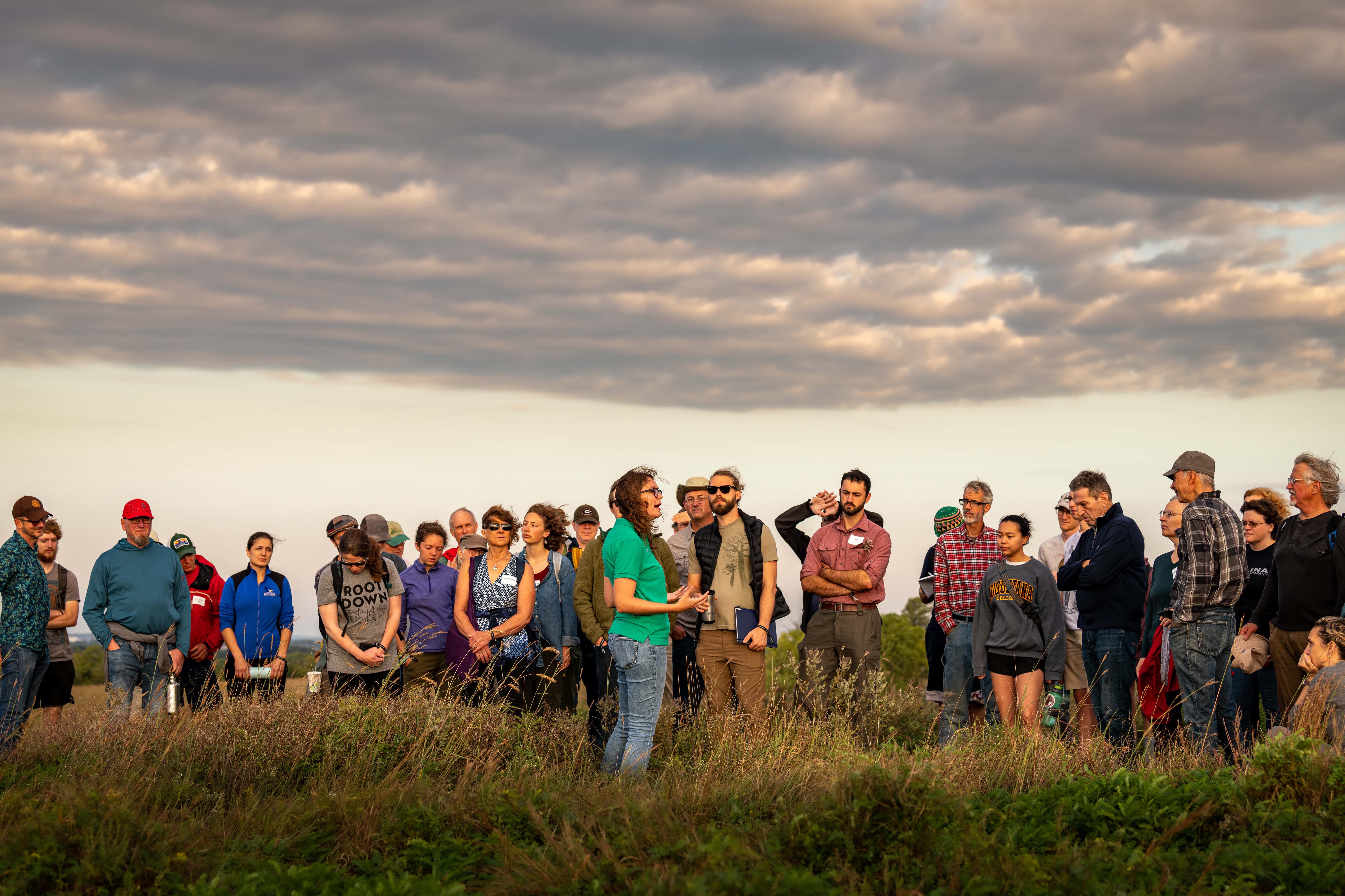 Aubrey Streit Krug, The Land Institute's director of Ecospheric Studies, talks of the prairie as she leads a sunrise prairie walk that is part of the institute's annual Prairie Festival.