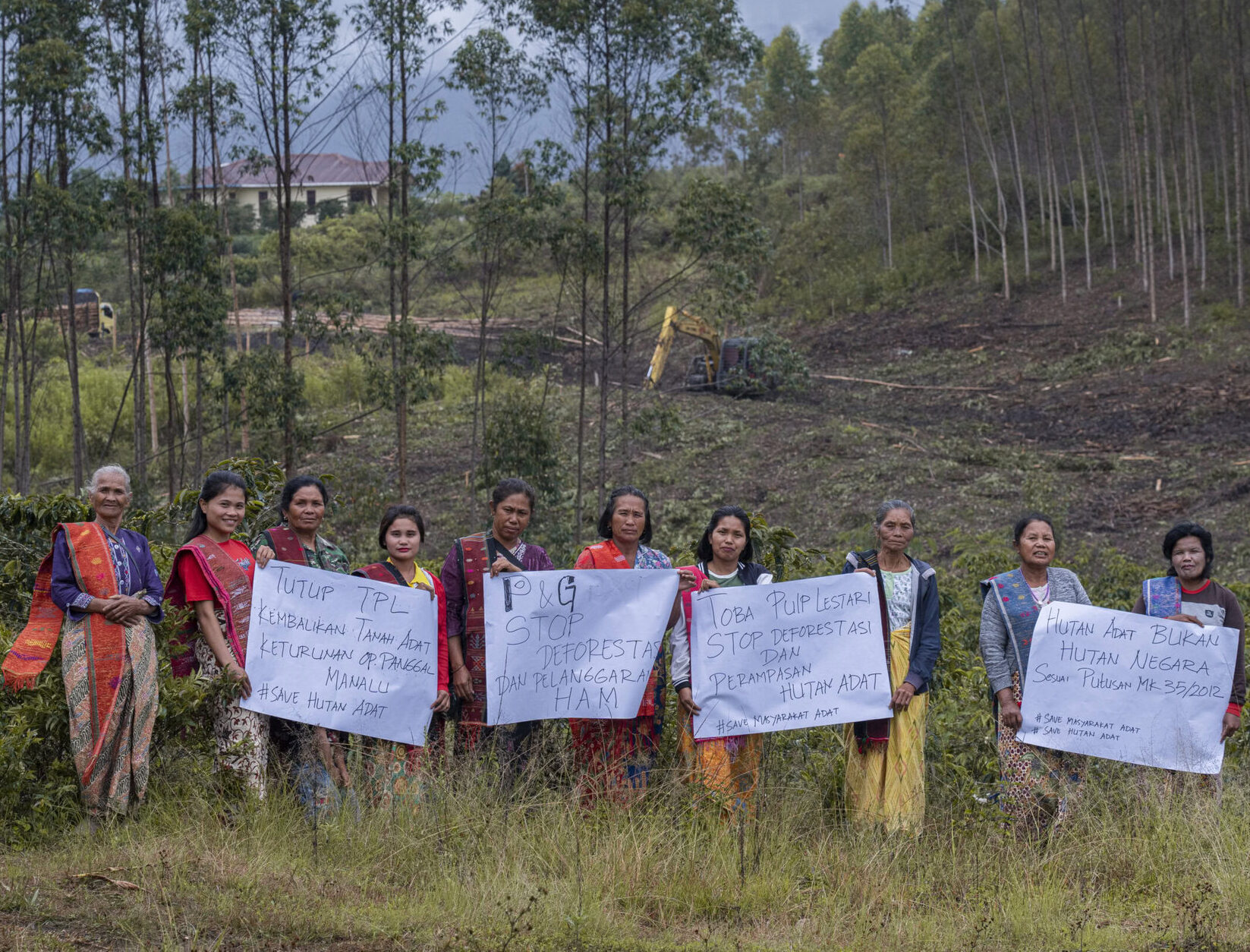Indigenous woman of Batak Toba hold a posters in PT. Toba Pulp Lestari (PT. TPL) land during protest in Aek Raja Village, North Sumatra, on September 29, 2023.