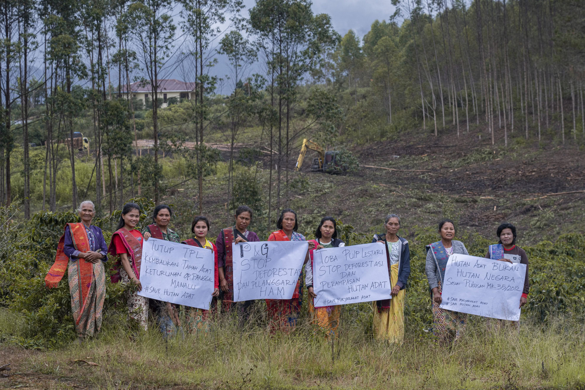 Indigenous woman of Batak Toba hold a posters in PT. Toba Pulp Lestari (PT. TPL) land during protest in Aek Raja Village, North Sumatra, on September 29, 2023.