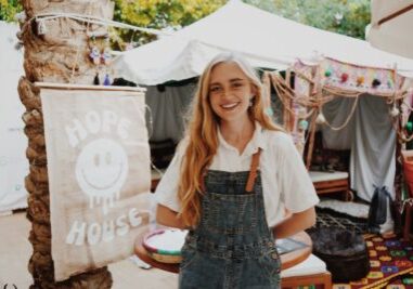 Charly Frisk, WEA Programs + Operations intern, and one of the programmers of "Hope House" a Time for Better x Sierra Quitiquit activation to inspire hope and optimism at COP27. Behind, a Bedouin tent which was installed with local collaborators. Credit: Bertold Weisner