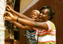 Rosemary and Jacqueline building a Ferro Cement Tank during the 2011 East Africa Women and Water Training in Uganda