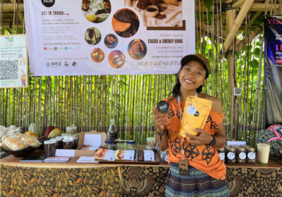 WEA Leader Tya Sari at an expo presenting Balini Organic's energy bars, a project supported by WEA.