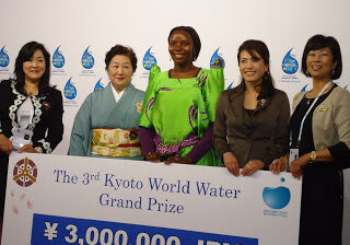 KWDT Co-ordinator Margaret Nakato receiving the prize